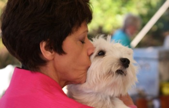 Naomi Brown kissing one of her West Highland White Terriers